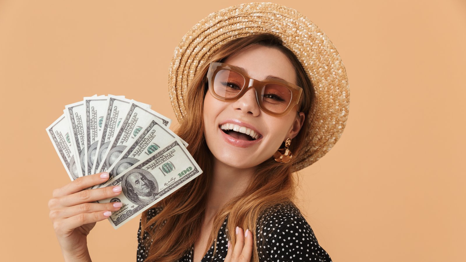 Woman holding money smiling